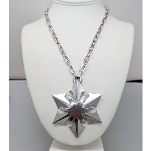 1970s rhodium plated star pendant on a chain with spring ring clasp necklace. Marked "TRIFARI©" with a crown over the T on...
