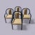 A set of four 1980s postmodern dining chairs with sculptural black lacquered metal frames and gold-tone patterned...