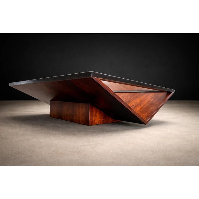 A refined and highly sculptural Brazilian modern coffee table attributed to Joaquim Tenreiro, dating to the 1960s—an...