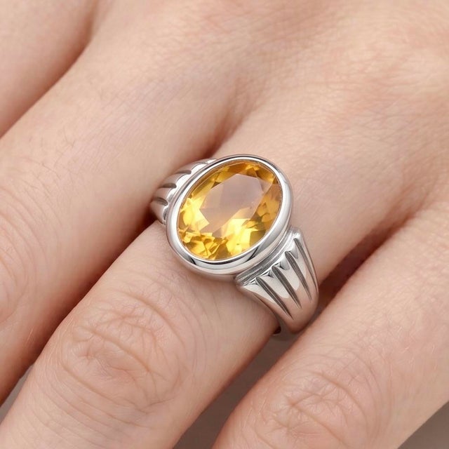 Refined and timeless, this elegant statement ring features a captivating Citrine gemstone, radiating warmth with its rich...