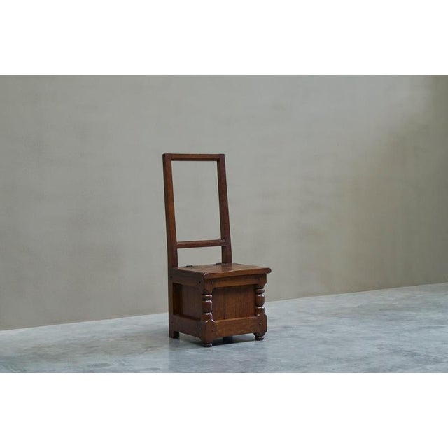An unusual chair in solid oak, strongly influenced by medieval and early vernacular furniture. Northern Europe, mid 20th...