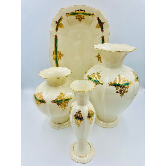 A beautifully coordinated Lenox porcelain garniture set featuring three matching vases and an accompanying tray, richly...