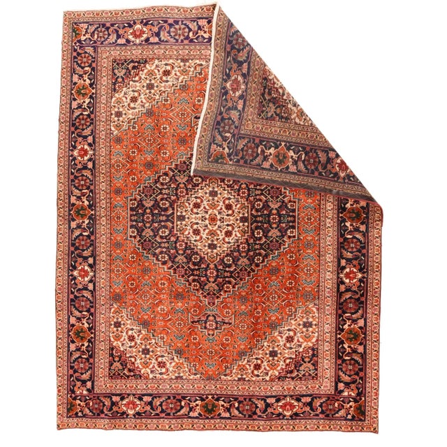 All Herati, going in from the navy corner cores, to the ecru stepped corners, the rust field, stepped navy medallion with...