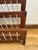 A unique vintage find for the collector of mid-century design — this wooden magazine rack features a solid wood frame with...
