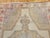 4’ 5” x 7’ 2” Vintage Turkish Oushak hand knotted area rug in soft colors including ivory, pale yellow, pink, purple, and...