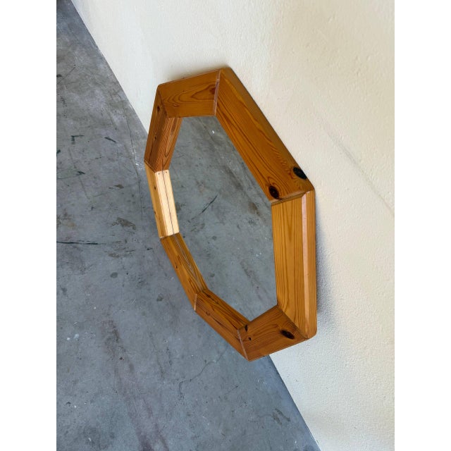 Striking vintage Danish octagonal wall mirror featuring a bold geometric silhouette and warm natural wood frame. The...