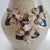 This handcrafted stoneware pitcher featuring applied dogwood blossoms and leaves is an authentic piece of Southern folk...