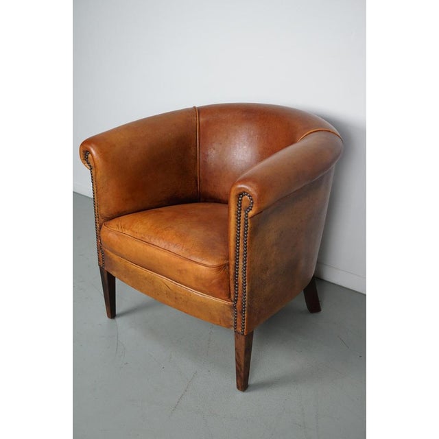 This cognac-colored leather club chair comes from the Netherlands. It is upholstered with cognac-colored leather and...