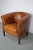 This cognac-colored leather club chair comes from the Netherlands. It is upholstered with cognac-colored leather and...