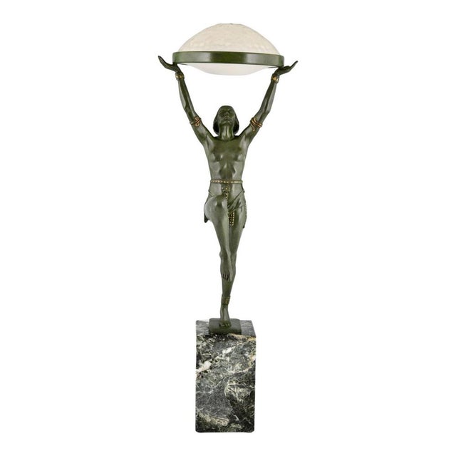 Art Deco lamp with dancer, Danseuse à la coupe, by Max Le Verrier. Patinated metal, green marble, and glass. Signed on the...