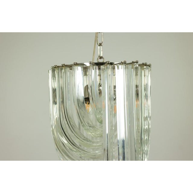 Venini. Murano glass pendant lamp, composed of curved, intertwined translucent glass tubes. 1980s. Italian design. This...