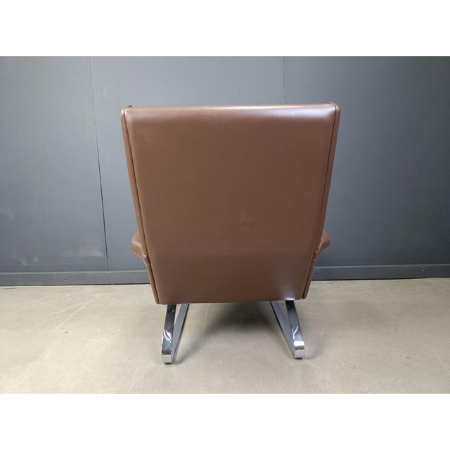 Swing armchair designed by Reinhold Adolf and Hans-Jürgen Schräpfer for COR Steel chromed frame with tan leather...