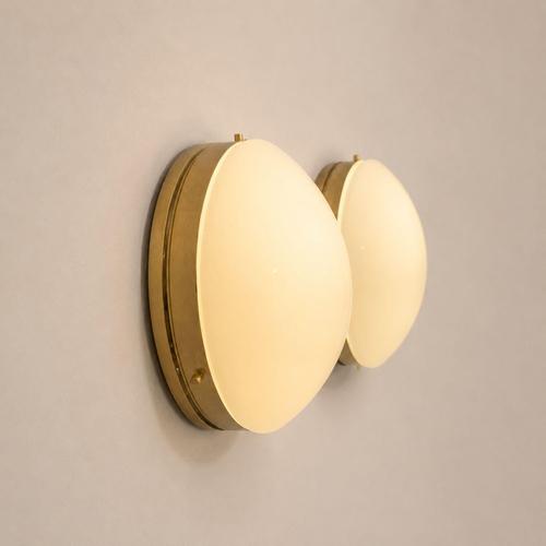 A pair of 1970s Italian wall lamps, crafted from white opal glass and polished brass, in the Stilnovo style. The design...