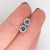 These classic design stud earrings feature two round 0.36 cttw blue diamonds with natural earth mined diamonds in all...