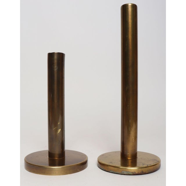 Elegant pair of patinated brass candlesticks - one tall, one short (ca. 1970s, USA). Composed of elongated tapers...