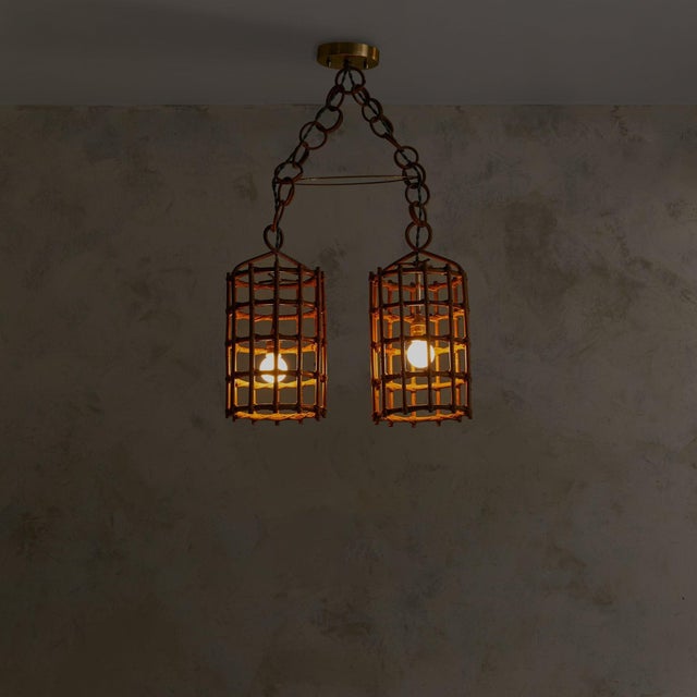 An Italian double lantern pendant from the 1960s, its cylindrical shades woven in warm bamboo. Each hangs from a chain of...