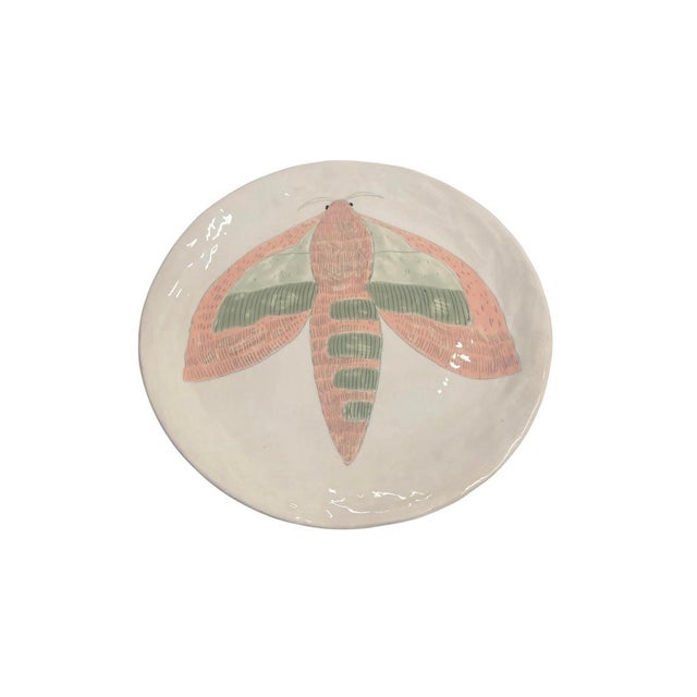 This charming vintage-inspired decorative ceramic charger plate features a beautifully hand-painted, stylized moth motif...