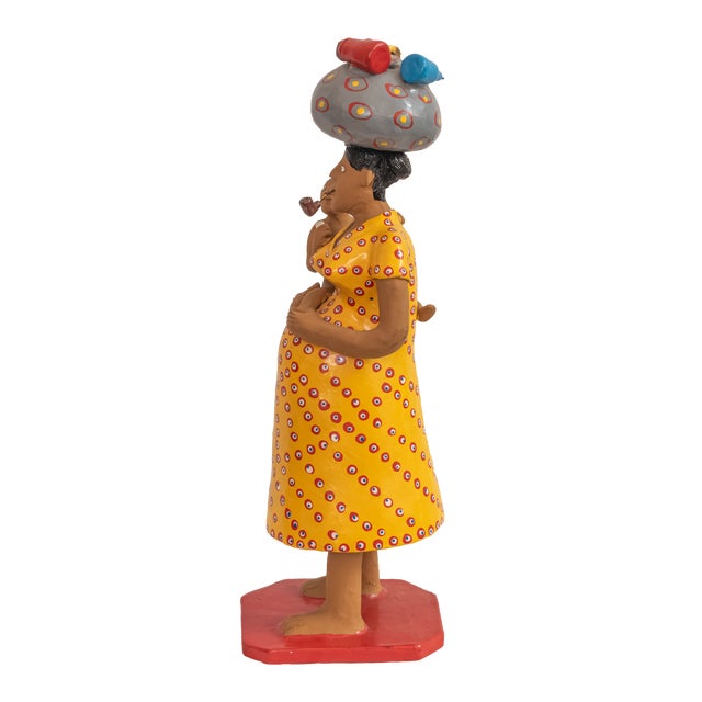 A vibrant and evocative piece of authentic Brazilian popular art, this hand-painted clay sculpture captures the heart and...