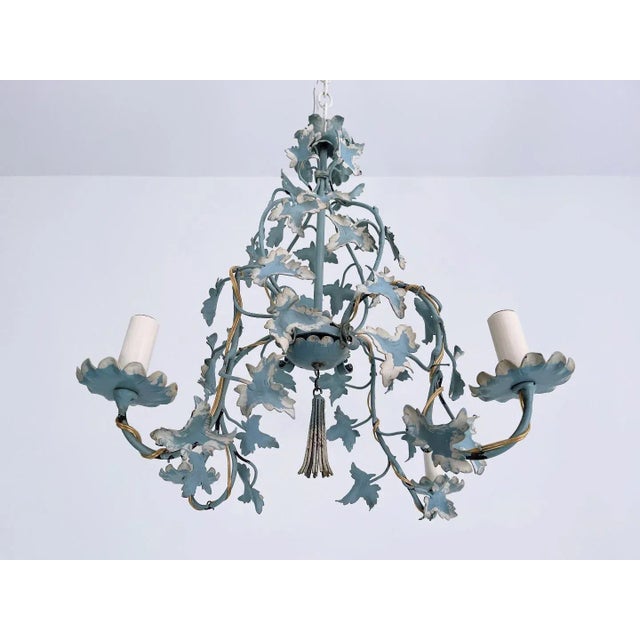 Lovely Italian tole four-arm chandelier featuring a soft matte blue frame festooned with trailing ivy vines, scalloped...