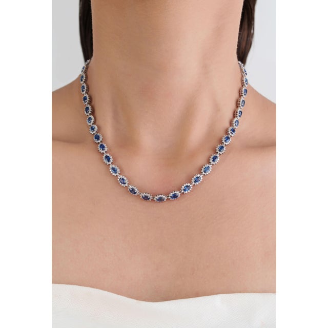This luxurious Tennis Necklace showcases 13.61 carats of natural oval blue sapphires, set in 14K White Gold. Each sapphire...
