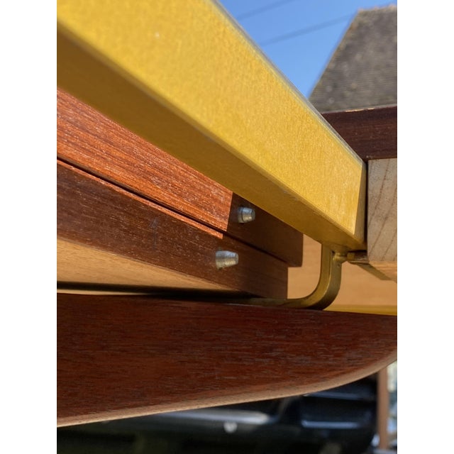 Beautiful oval extendable dining table in rosewood and rosewood veneer Baumann edition from the 1960s This table has two...