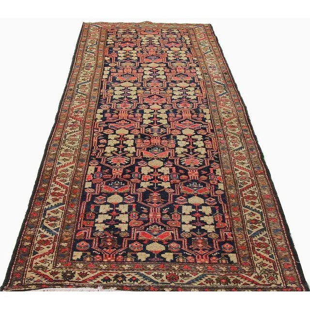 Traditional Vintage Handwoven Persian Malayer Area Rug featuring an allover design in a navy-colored field enclosed in an...
