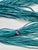 Bought in South Africa in the early 2000s. This is an 18-strand “seed”- sized glass-beaded necklace. Primarily turquoise-...
