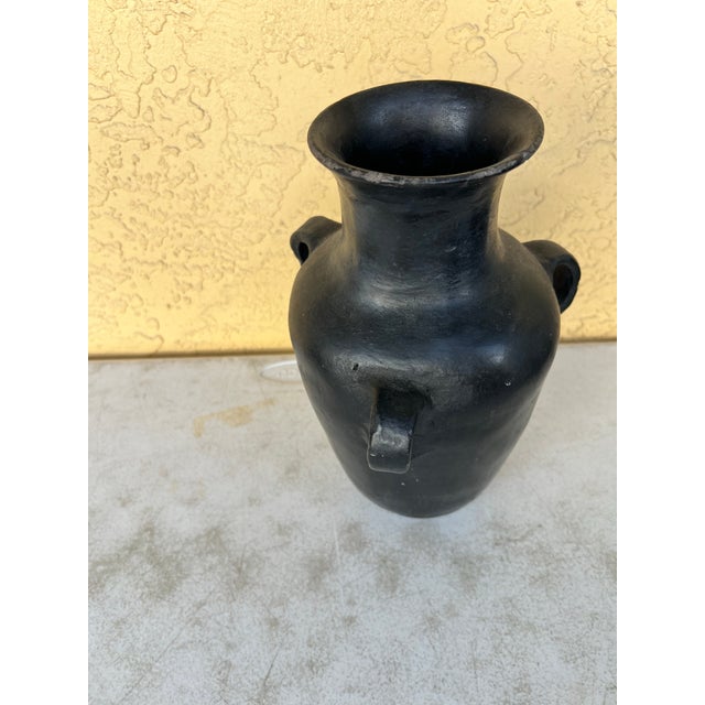 Bring organic texture and an artisanal, sculptural presence to your space with this striking matte black terracotta...