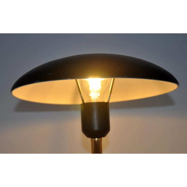 This iconic “Minou” table or desk lamp was designed in the 1950s by the famous architect and designer Louis Kalff and is...