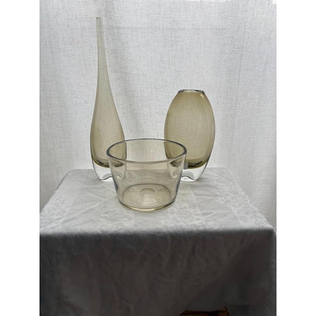 Refined Swedish modern glass set designed by Bengt Orup for Johansfors in the 1960s. This elegant ensemble includes two...