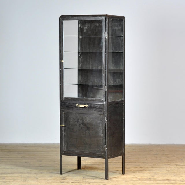 Medicine cabinet from the 1950s, manufactured in former Yugoslavia. This cabinet is made of iron and glass, creating a...