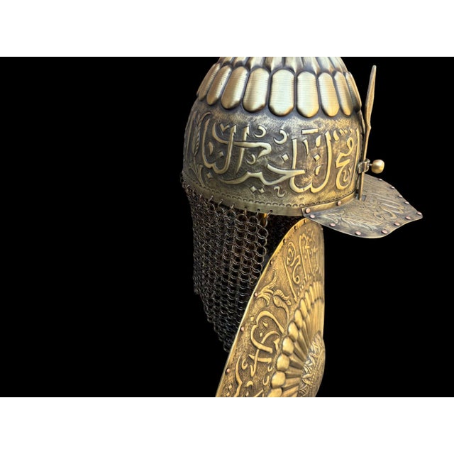 A fluted two-tone dome rises entirely in brass, alternating polished and darker aged brass panels, engraved with flowing...