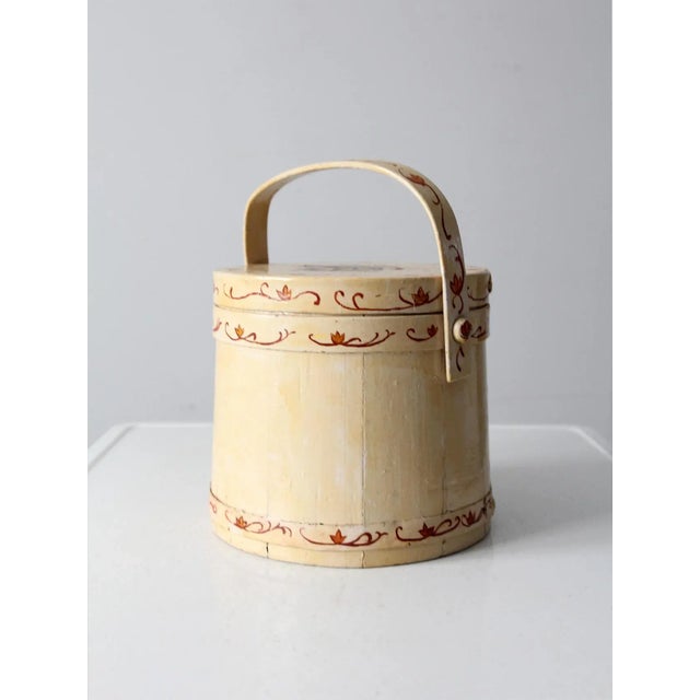This is a vintage sugar bucket or firkin. Hand-painted scrolled flowers and paisley adorn the wooden barrel style basket....