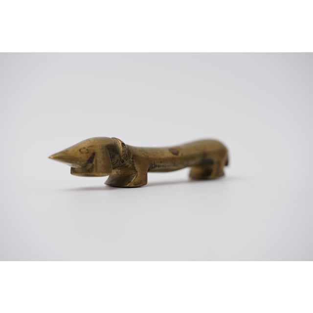 Object: Bottle opener in the shape of a dachshund Designer: Walter Bosse (1904–1979) Age: 1950s/1960s Material: Brass...
