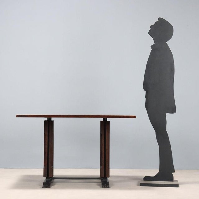 Table with enamelled metal base, exotic wood veneer. This piece is attributed to the mentioned designer/maker. It has no...