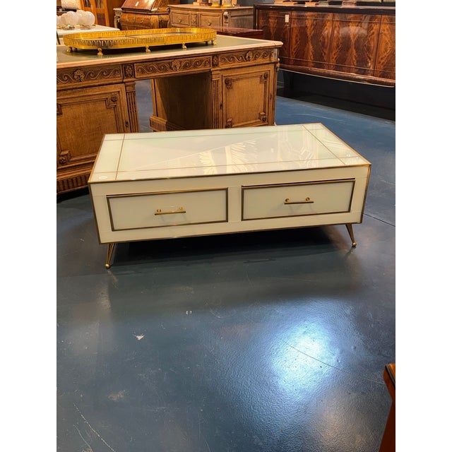 Elegance and sophistication are the key elements of this Italian glass and brass coffee table. The combination of sleek...