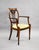 An elegant pair of Edwardian Sheraton Revival mahogany armchairs, displaying refined neoclassical detailing throughout....