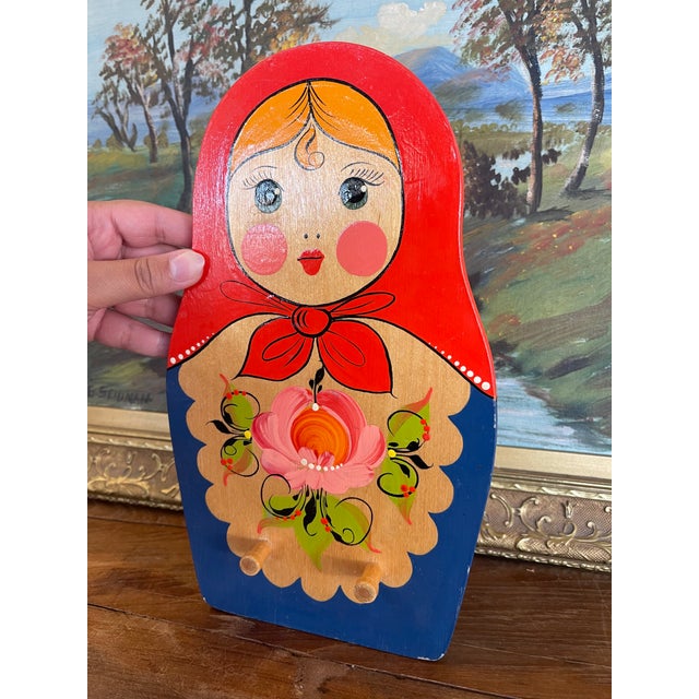 Charming vintage wooden wall hook rack crafted in the shape of a traditional Russian matryoshka doll. This piece is hand-...