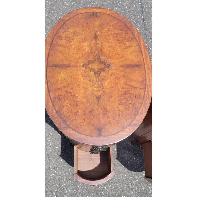 A fabulous and rare pair of tall four drawer French inlaid wood oval nightstands or end tables. Features a towering form...