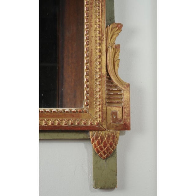 A distinguished early 19th century Adams-style giltwood mirror, richly carved with classical neoclassical ornament and...