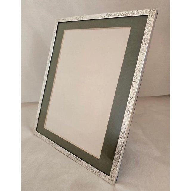 A handsome vintage chinese export photograph frame, finely crafted with a substantial sterling silver mount and attributed...