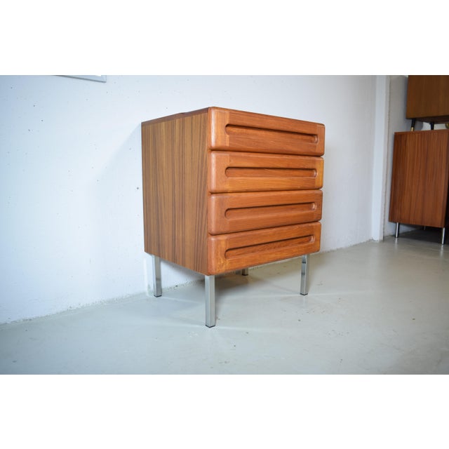 This is a vintage chest of drawers from the Danish manufacturer Kollund Möbler. The chest features a cubic design with a...