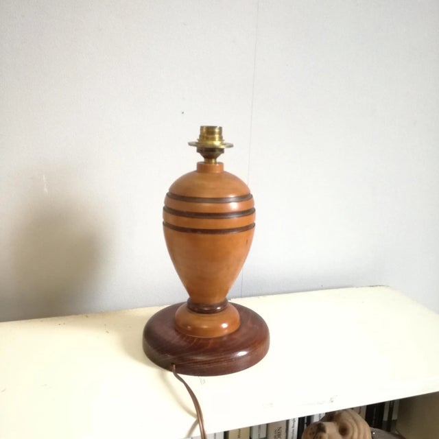 Wooden lamp base turned into a bomb shape -standard B22 brass socket -weight 1 kg European Plug (up to 250V).The wiring of...