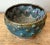 This mesmerizing studio pottery bowl is defined by its deep, rich coloration and unique textural elements. The piece...