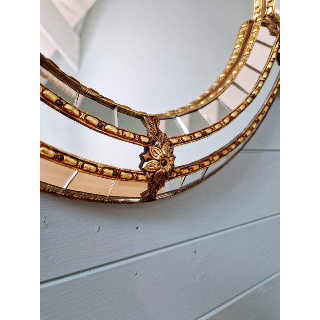 Large Hollywood Regency style mirror, produced in Spain in the 1970s-80s. Beautiful glass mosaic and brass garland. Very...