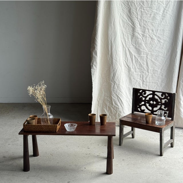 Small bench with a carved backrest featuring a rosette and scroll motif. A small piece of children's furniture, second-...