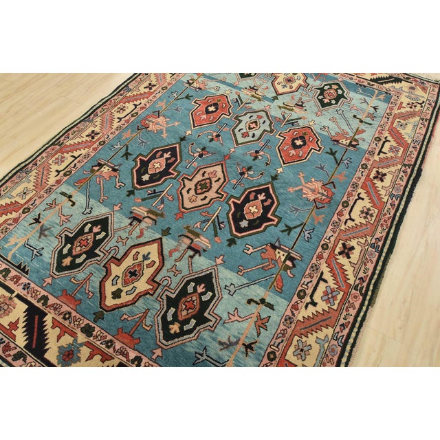 An authentic vintage tribal Heriz rug hand-knotted with fine wool on a cotton foundation. This rug features geometric...