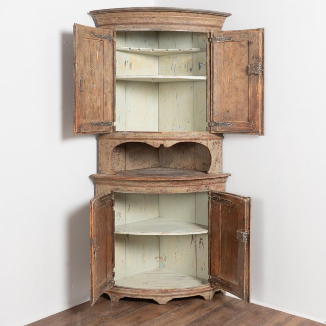 19th-century Swedish pine corner cabinet with curved bowfront form, built in 2 sections for easier transportation and...