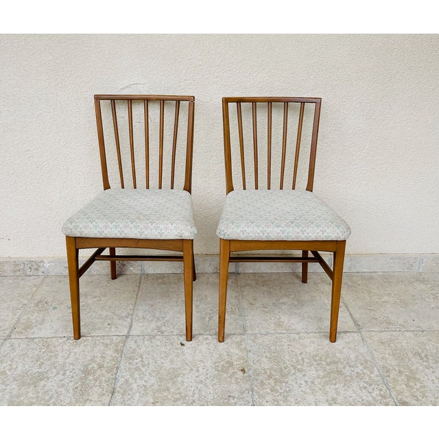Elegant and timeless, these two vintage chairs are distinguished by their gently curved, vertical spindle backs, offering...