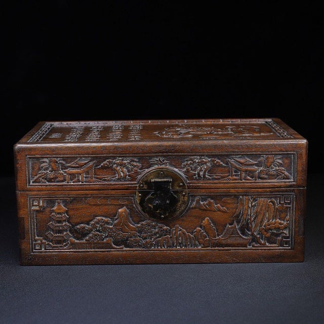 A beautifully crafted Chinese hardwood box, likely made of Huali (rosewood), featuring deep relief carvings throughout....